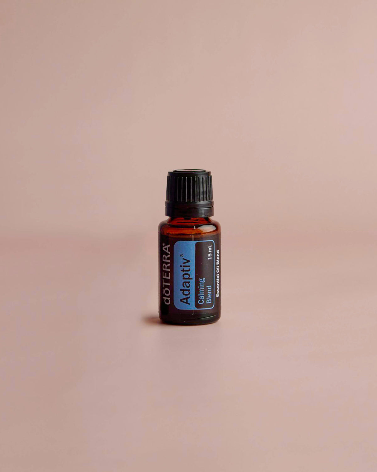 Adaptiv mélange d'huiles essentielles dōTERRA, flacon sur fond beige rosé