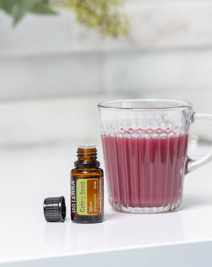 Graines de céleri huile essentielle dōTERRA, flacon et verre de jus