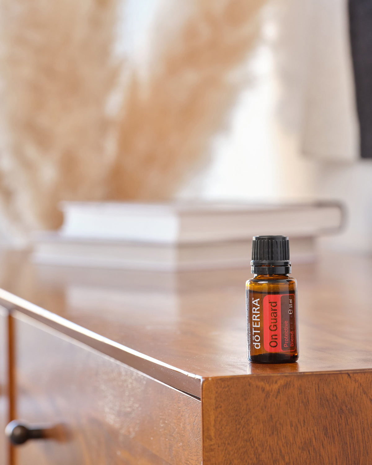 On Guard mélange d'huiles essentielles dōTERRA, flacon avec une bougie