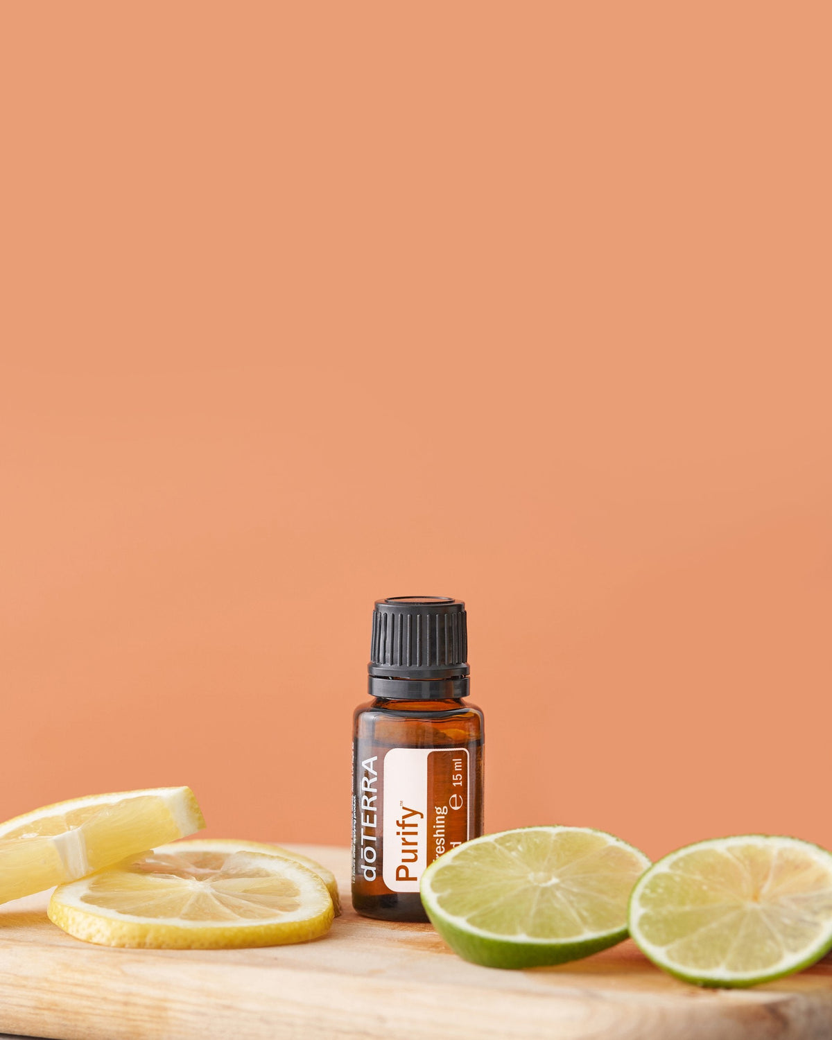 Purify mélange d'huiles essentielles dōTERRA, flacon sur fond pêche
